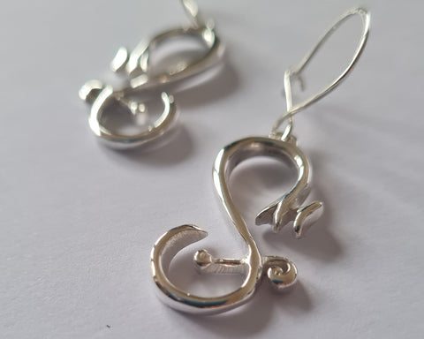 A pair of sterling silver drop earrings shaped like bicycles with infinity symbols integrated into the design, displayed on a white background.