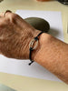Sterling silver rugby ball link on braided bracelet.