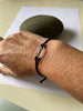Sterling silver rugby ball link on braided bracelet.
