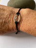 Sterling silver rugby ball link on braided bracelet.