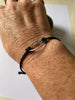 Sterling silver rugby ball link on braided bracelet.