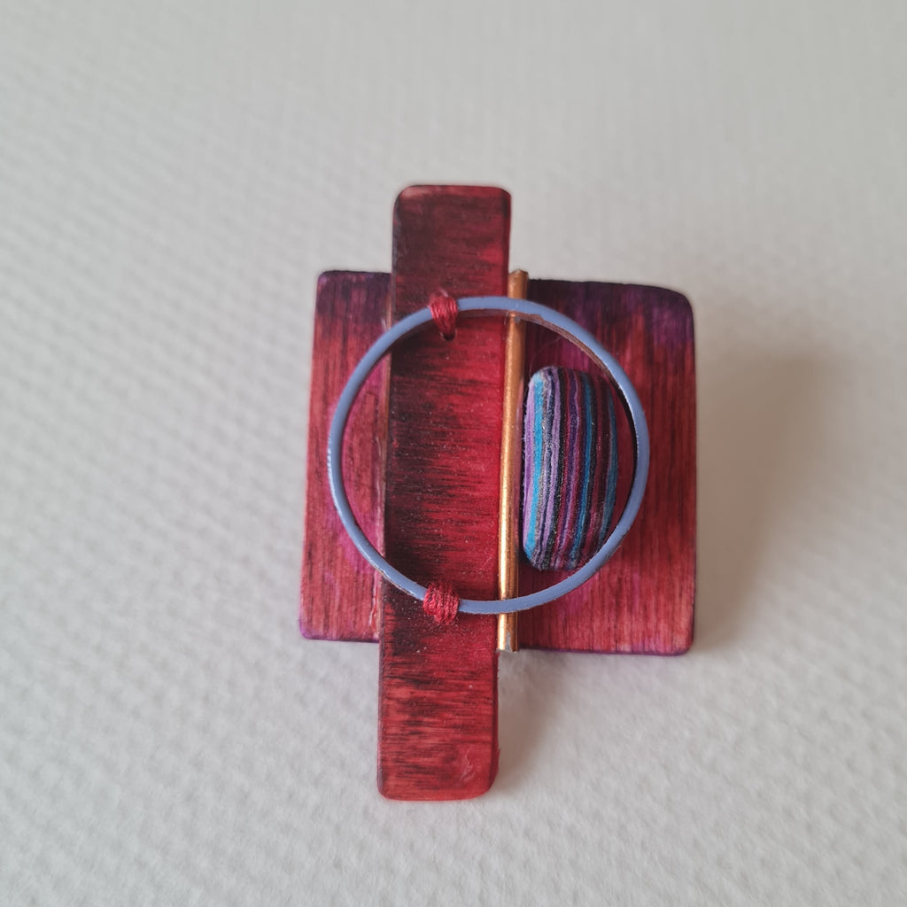 Wood, paper, enamel and copper brooch