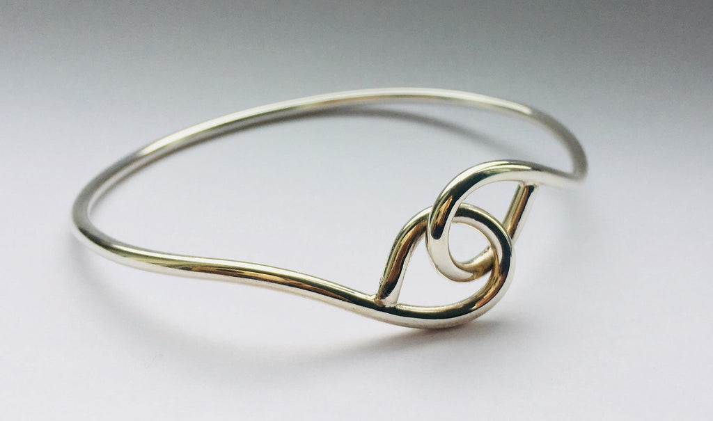 Solid silver cross over loop oval Bangle